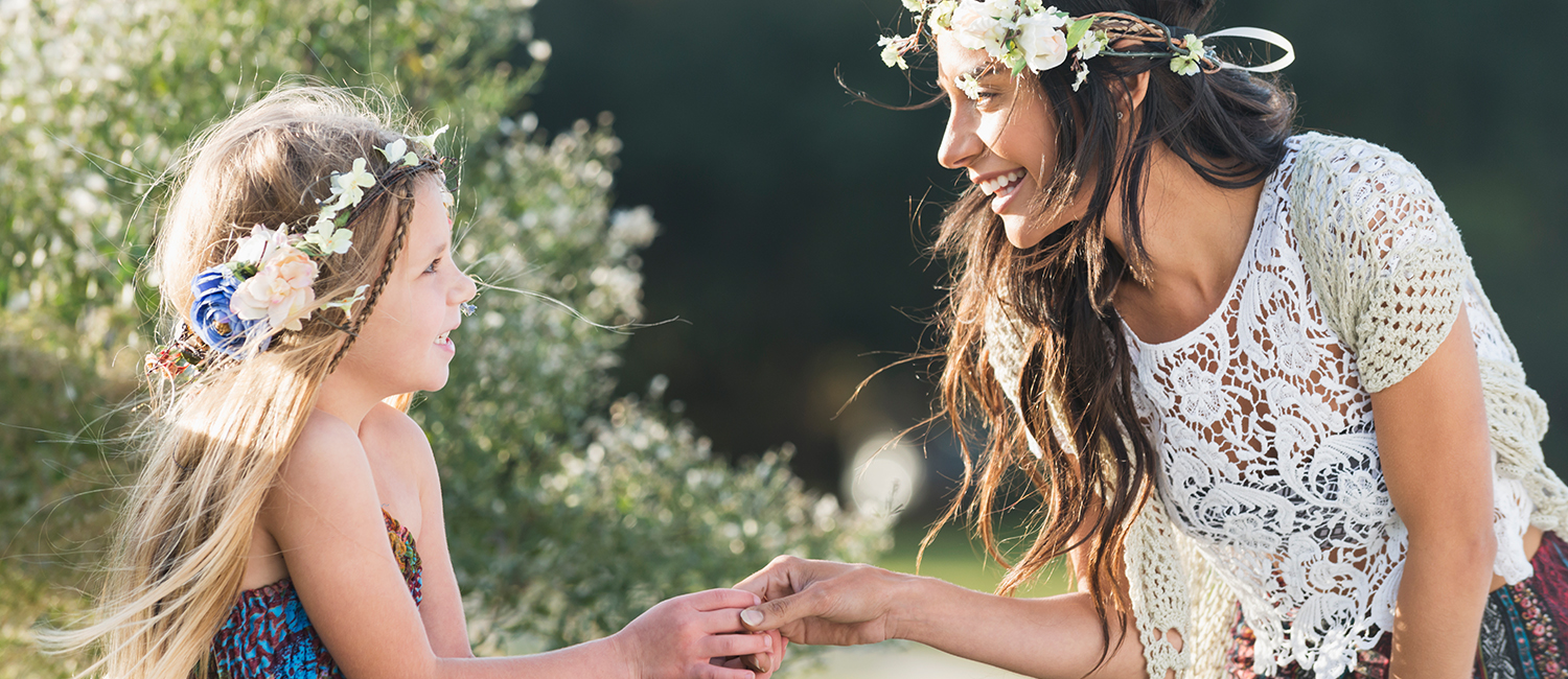  Boho-chic young woman and little girl holding hands. 